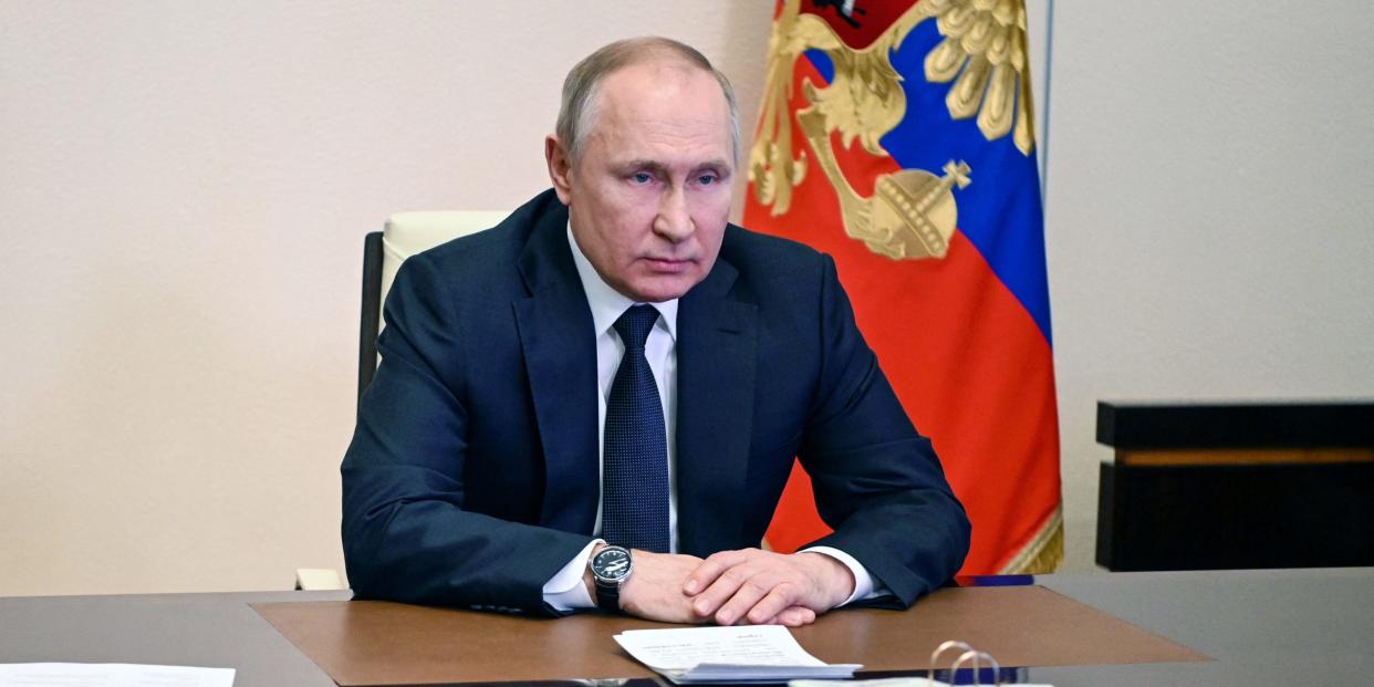 Vladimir Putin behind a desk