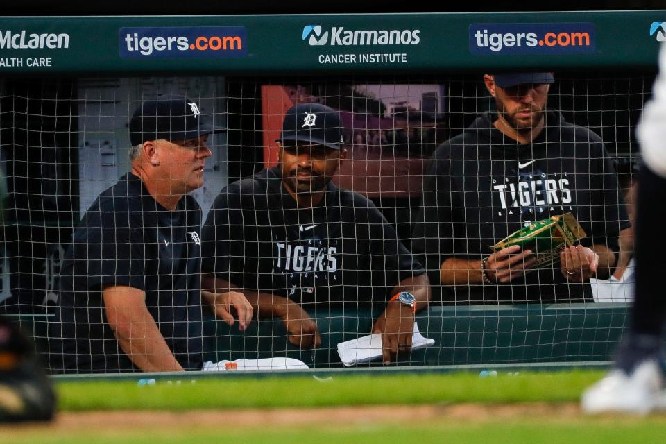 From left, Detroit Tigers manager A.J. Hinch (14) talks to bench coach George Lombard (26) and pitching coach Chris Fetter (41) during the eighth inning against the Oakland Athletics at Comerica Park in Detroit on Wednesday, July 5, 2023.