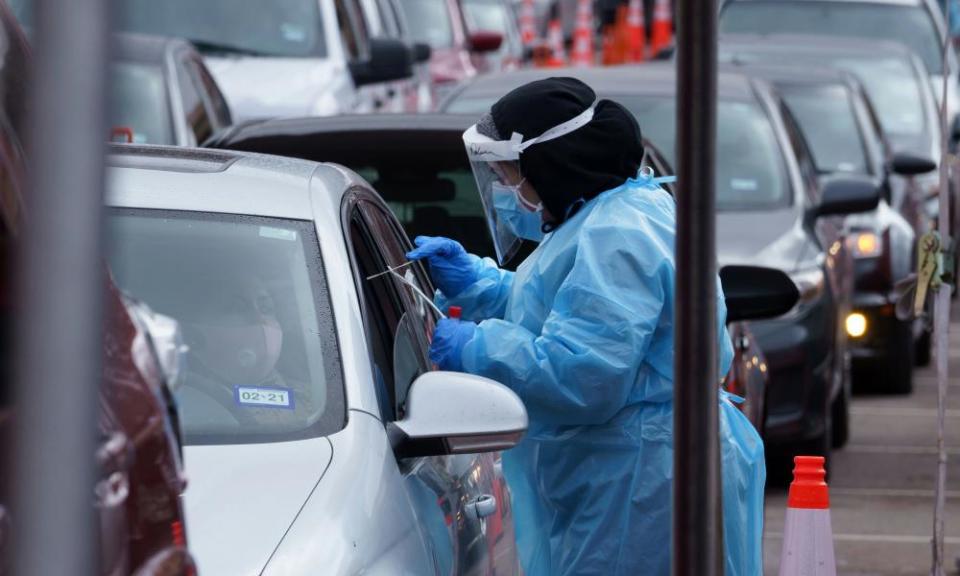 A nurse takes a swab sample at a drive-through coronavirus disease test site at the University of Texas El Paso in El Paso, Texas, this week.