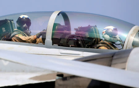 U.S. navy pilots are pictured inside the cockpit of F18 fighter jet moments before flying over the South China Sea during a FONOPS (Freedom of Navigation Operation Patrol), March 3, 2017. REUTERS/Erik De Castro