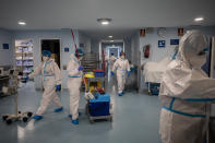 Staffers of the Severo Ochoa Hospital work at the COVID-19 ward in Leganes on the outskirts of Madrid, Spain, Wednesday, Feb. 17, 2021. One year ago, staff had to deal with the exasperation of fighting an unknown enemy, the fear of bringing the virus back home, the scarcity of protective gear and the bodies lined up in the morgue. (AP Photo/Bernat Armangue)