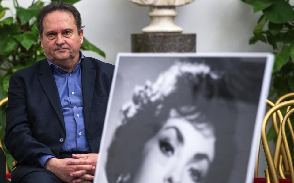 Milko Skofic Jr beside a photo of his late mother - Angelo Carconi/EPA-EFE/Shutterstock