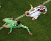 Algeria's Rafik Halliche commits a foul on Germany's Bastian Schweinsteiger (R) during their 2014 World Cup round of 16 game at the Beira Rio stadium in Porto Alegre June 30, 2014. REUTERS/Fabrizio Bensch