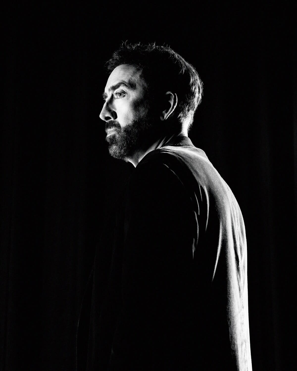 A black-and-white portrait of Nicolas Cage