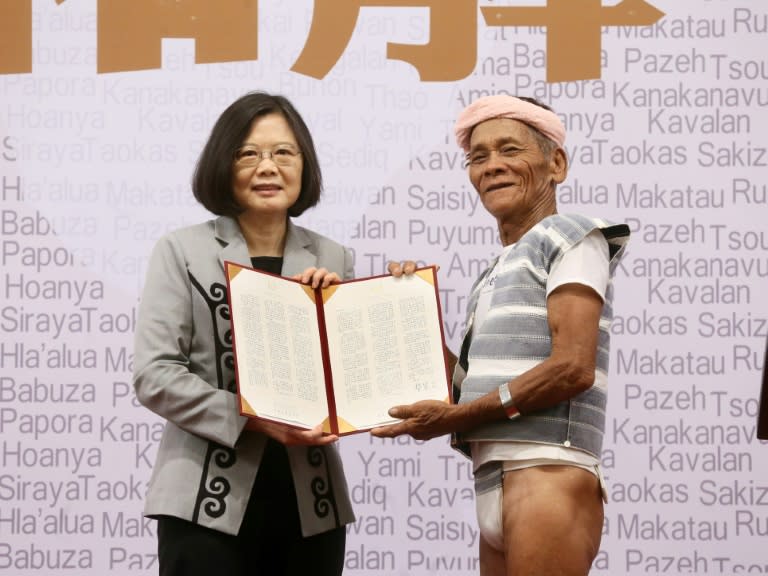 Taiwanese President Tsai Ing-wen poses with 80-year-old Yami leader Capen Nganaen as she welcomes indigenous community members to her office in Taipei on August 1, 2016