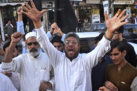 Pakistan traders chant anti-French slogans against the publishing of caricatures of the Prophet Muhammad they deem blasphemous, in Peshawar, Pakistan, Monday, Oct. 26, 2020. Pakistan's Prime Minister Imran Khan said the French leader chose to encourage anti-Muslim sentiment and deliberately provoke Muslims by encouraging the display of blasphemous cartoons targeting Islam. (AP Photo/Muhammad Sajjad)