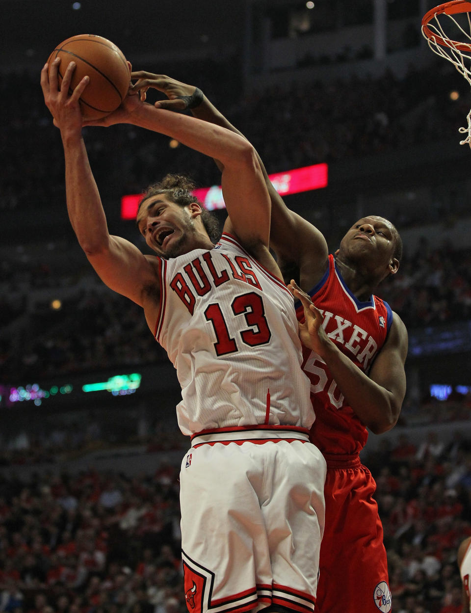 CHICAGO, IL - MAY 01: Joakim Noah #13 of the Chicago Bulls grabs a rebound away from Lavoy Allen #50 of the Philadelphia 76ers in Game Two of the Eastern Conference Quarterfinals during the 2012 NBA Playoffs at the United Center on May 1, 2012 in Chicago, Illinois. NOTE TO USER: User expressly acknowledges and agrees that, by downloading and or using this photograph, User is consenting to the terms and conditions of the Getty Images License Agreement. (Photo by Jonathan Daniel/Getty Images)