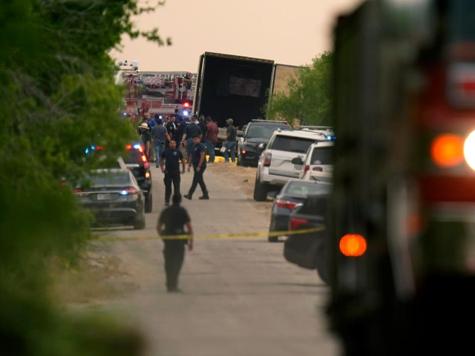 Body bags lie at the scene where a tractor trailer with multiple dead bodies was discovered, Monday, June 27, 2022, in San Antonio.