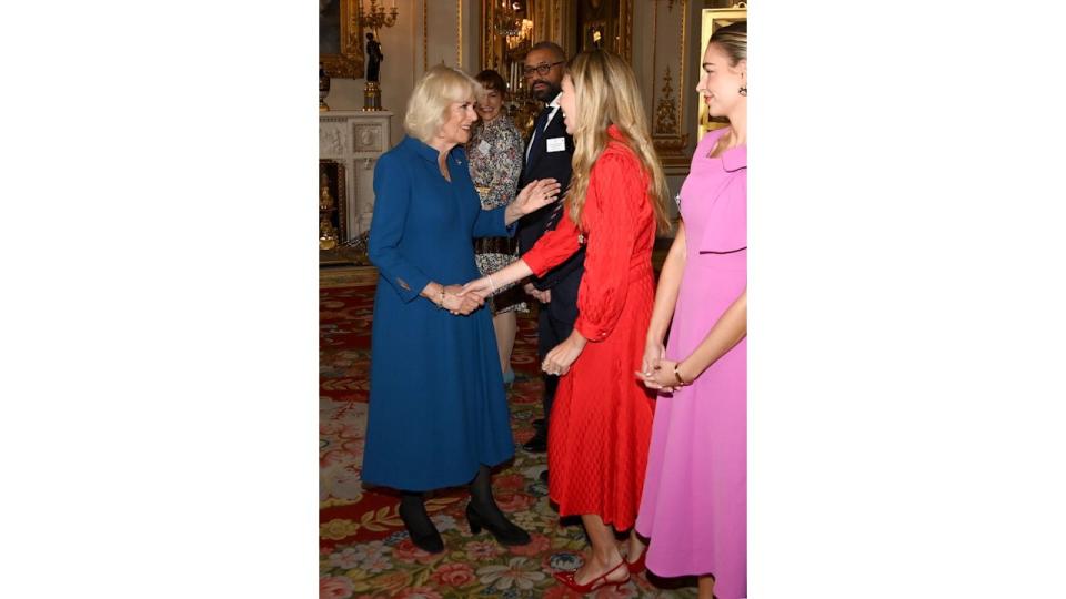 Queen Camilla shakes hands with Carrie Johnson 