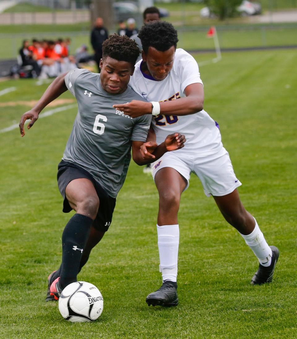 Stani Venus, left, of Hoover and Aiden Njuguna Maina of Waukee battle for the ball during a game at Hoover on Monday.