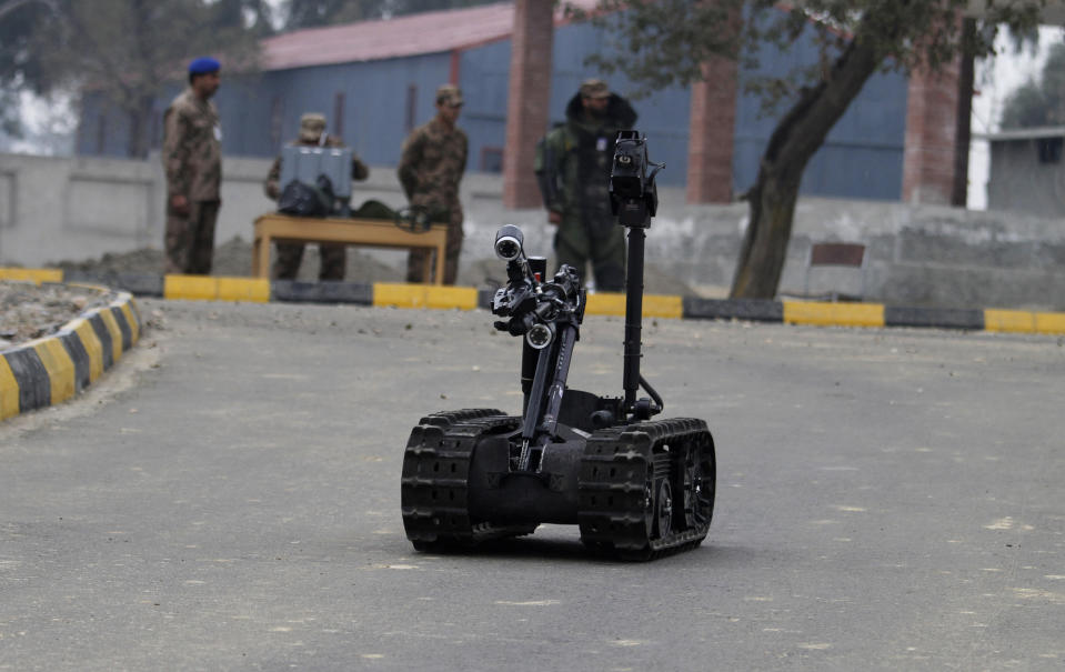 In this Wednesday, Jan. 8, 2014, photo, Pakistani soldiers use remote controlled vehicle to approach possible explosive devices during a training session at the Counter IED Explosives and Munitions School, in Risalpur, Pakistan. Soldiers of the Pakistani security forces learn exactly these types of scenarios to deal with the improvised bombs that have become increasingly popular in wars like Iraq, Afghanistan and the insurgency that Pakistan's forces are fighting in the northwestern tribal areas. (AP Photo/Anjum Naveed)