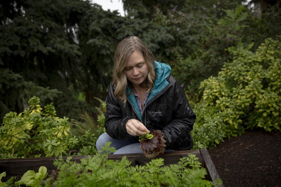 Amelia Huntsberger, an OB/GYN who left Idaho for Oregon, tends to a garden at her new home on Oct. 13, 2023. (Moriah Ratner for The Washington Post)