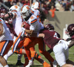 Syracuse quarterback Garrett Shrader (16) is tackled by Virginia Tech linebacker Dax Hollifield (4) during the first half of of an NCAA college football game in Blacksburg Va., Saturday, Oct. 23 2021. (Matt Gentry/The Roanoke Times via AP)