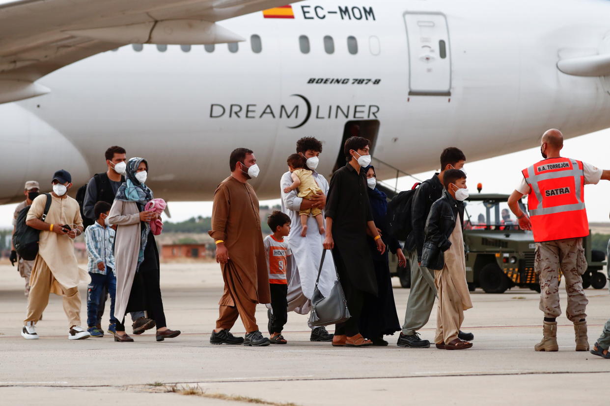 Afghan citizens who have been evacuated from Kabul arrive at Torrejon Air Base in Torrejon de Ardoz, outside Madrid, Spain, August 24, 2021. REUTERS/Javier Barbancho