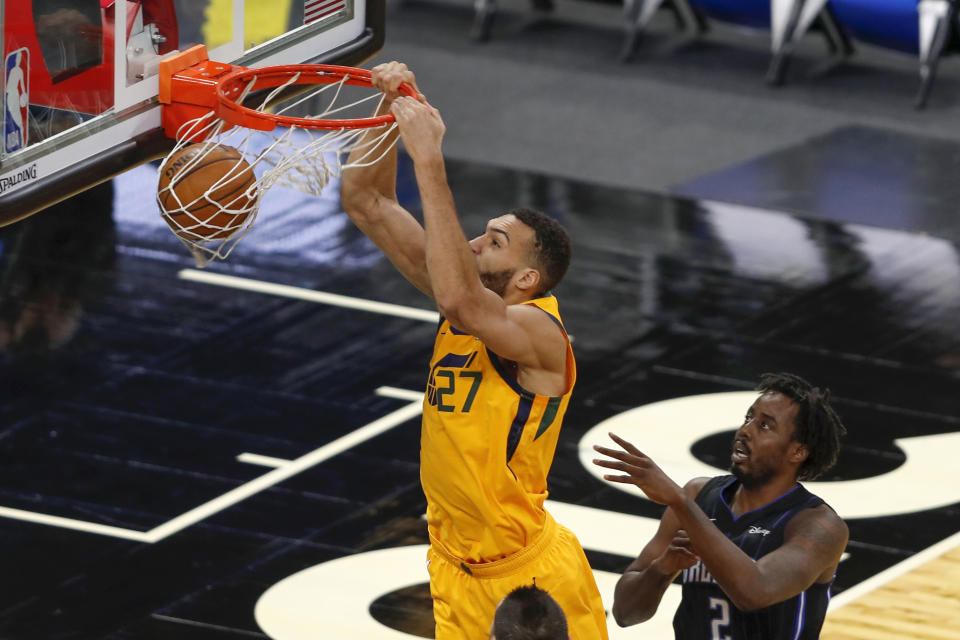 Utah Jazz center Rudy Gobert (27) scores in front of Orlando Magic forward Al-Farouq Aminu (2) in the first quarter during an NBA basketball game, Saturday Feb. 27, 2021, in Orlando, Fla. (AP Photo/Joe Skipper)