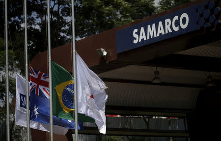 FILE PHOTO: An Australian flag (2nd L) and a Brazilian flag (2nd R) are pictured at the entrance of mine operator Samarco owned by Vale SA and BHP Billiton Ltd in Mariana, Brazil, November 11, 2015. REUTERS/Ricardo Moraes/File Photo