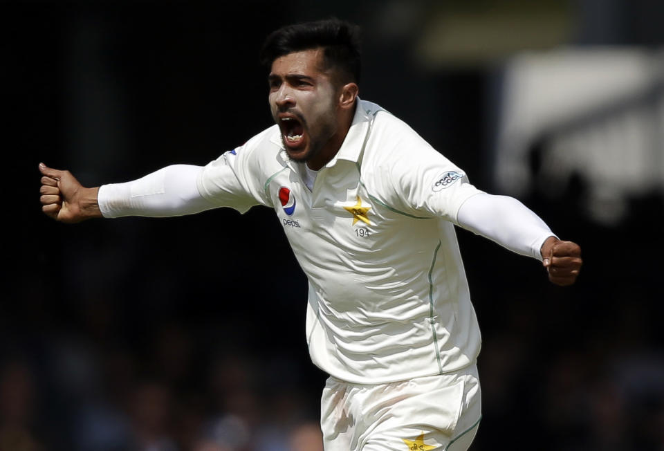 FILE - In this Saturday, May 26, 2018, file photo, Pakistan's Mohammad Amir celebrates during a first test cricket match at Lord's cricket ground in London. Pakistan has dropped out-of-form fast bowler Amir and included 18-year-old paceman Mohammad Hasnain in its 15-member World Cup squad. Amir's exclusion came after the left-armer took only five wickets in 14 ODIs since Pakistan won the Champions Trophy in 2017. (AP Photo/Alastair Grant, File)