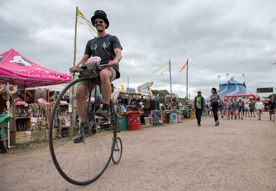 <p>GLAA man rides a penny farthing bicycle from the Circus Big Top tent at Glastonbury Festival Site on Worthy Farm in Pilton on June 23, 2017 near Glastonbury, England. (Photo: Chris J Ratcliffe/Getty Images) </p>