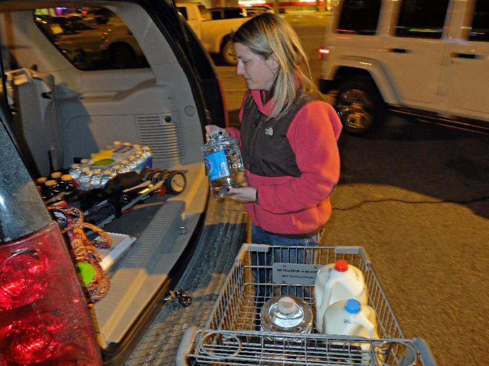 Laura John of Charleston, W.Va, drove across town to South Charleston, W.Va, to find water following a chemical spill on the Elk River that compromised the public water supply of eight counties of Thursday, Jan. 9, 2014. (AP Photo/Tyler Evert)