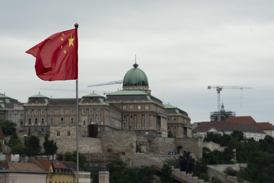 A Chinese national flag with the Buda Castle in the background waves in Budapest, Hungary, Wednesday, May 8, 2024. (AP Photo/Denes Erdos)