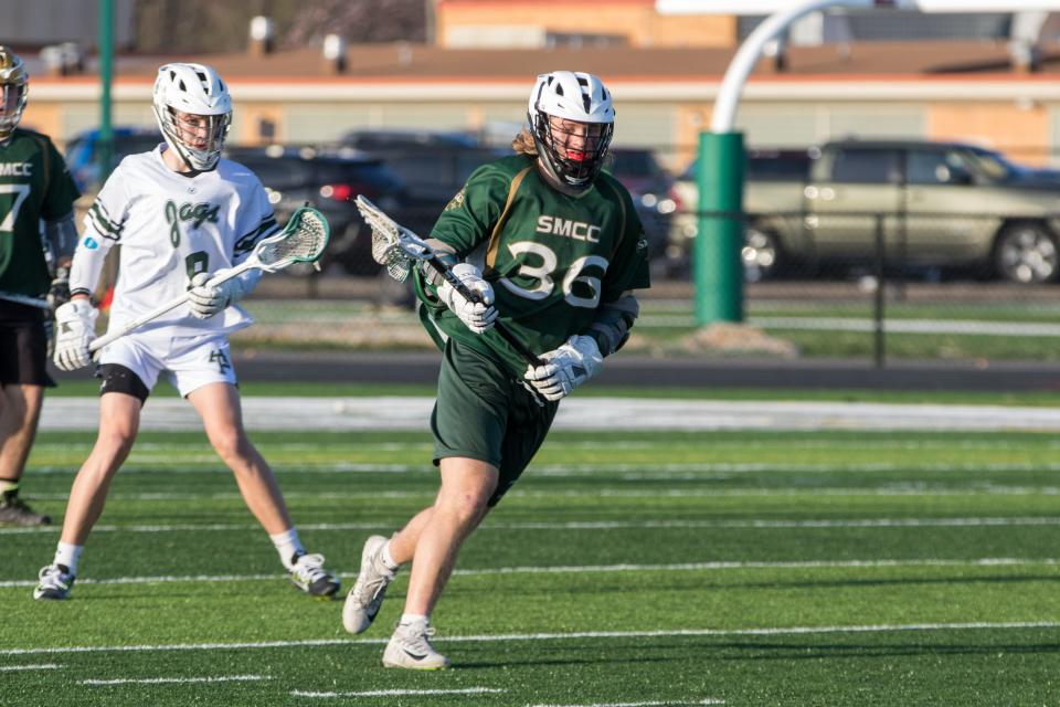 SMCC's Riley DeSarbo carries the ball against Allen Park for St. Mary Catholic Central's lacrosse team during a 15-4 win over Allen Park Thursday.