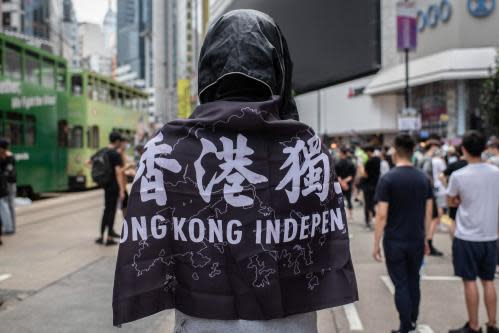 A protester wrapped in a pro-democracy flag before the law was enacted