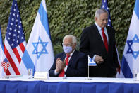 Israeli Prime Minister Benjamin Netanyahu, right, and U.S. Ambassador to Israel David Friedman, attend a ceremony to sign amendments to a series of scientific cooperation agreements, at Ariel University, in the West Bank settlement of Ariel, Wednesday, Oct. 28, 2020. The United States and Israel amended the agreements on Wednesday to include Israeli institutions in the West Bank, a step that further blurs the status of settlements widely considered illegal under international law. (Emil Salman/Pool via AP)