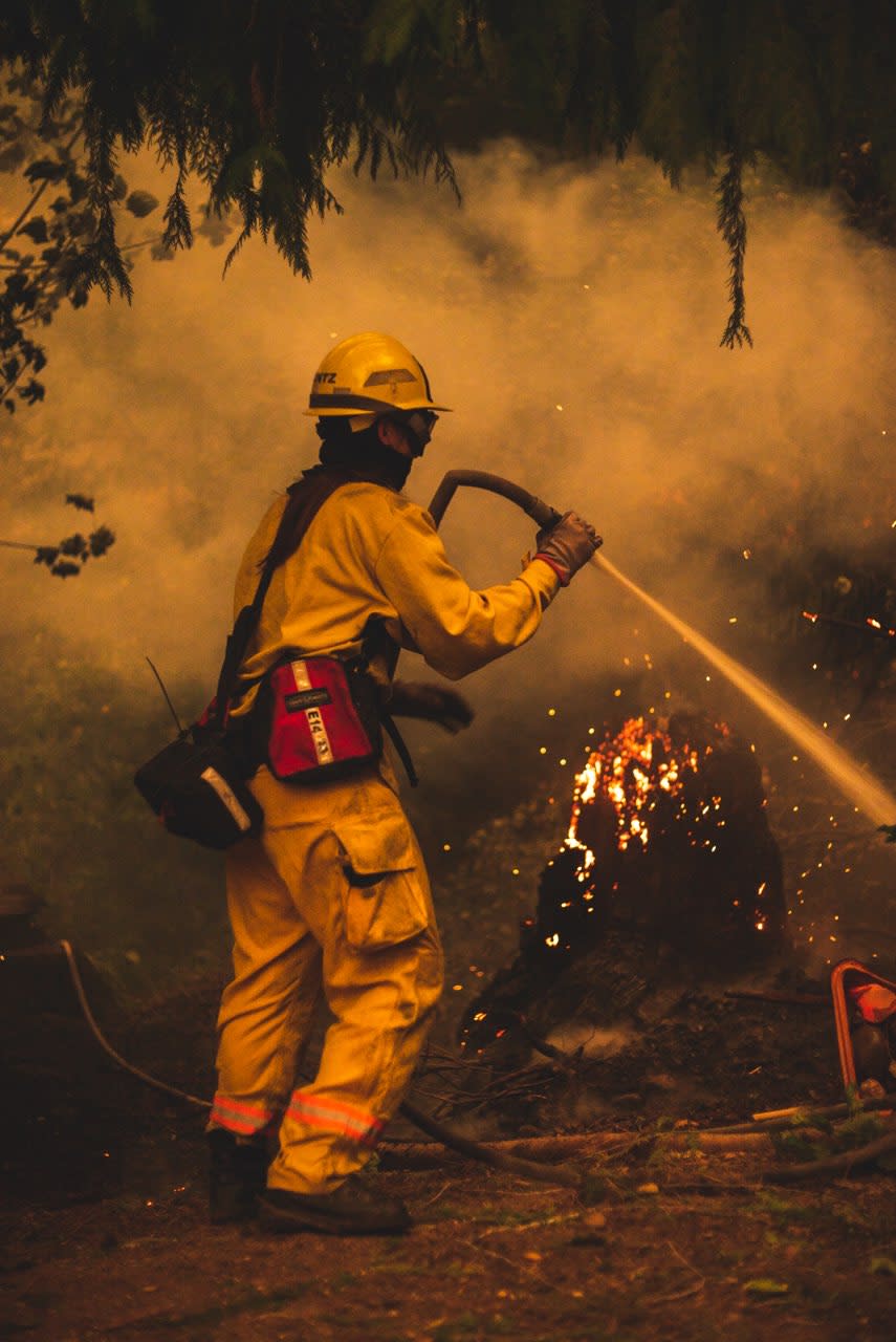 Jessie Hintz fights a fire in Estacada, Oregon, less than 30 miles away from her home. Photograph by Jordan Kelley (@jordanraykelley).