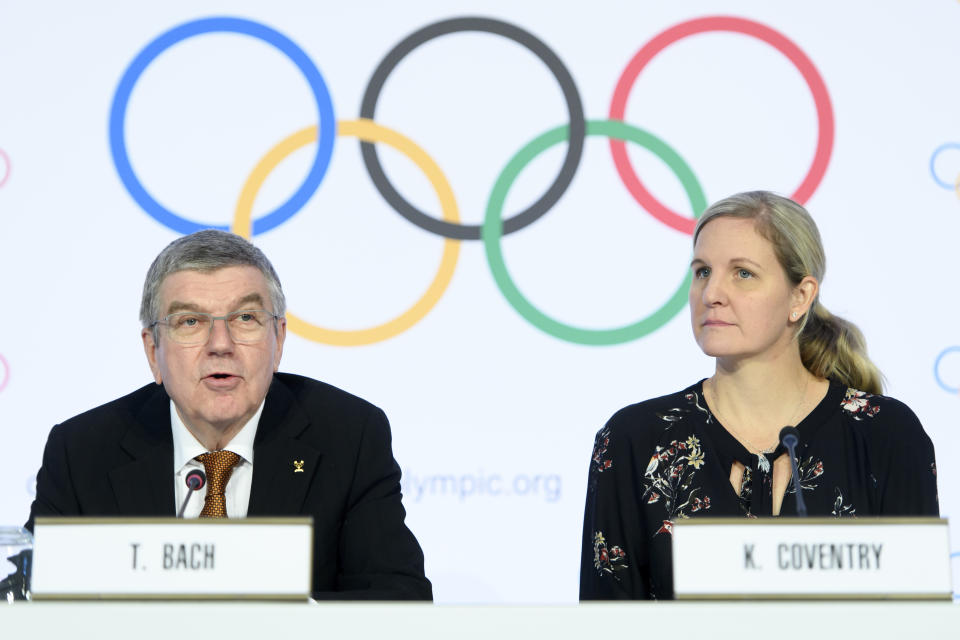 International Olympic Committee (IOC) president Thomas Bach, left, and IOC member and former swimmer Kirsty Coventry, right, speak during a press conference after the executive board meeting of the IOC, at the Olympic House, in Lausanne, Switzerland, Thursday, Jan. 9, 2020. (Laurent Gillieron/Keystone via AP)