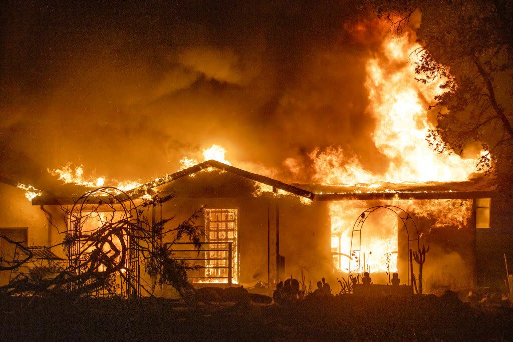 In this Sept. 27, 2020, photo, a house burns on Platina Road in the Zogg Fire near Ono, Calif.