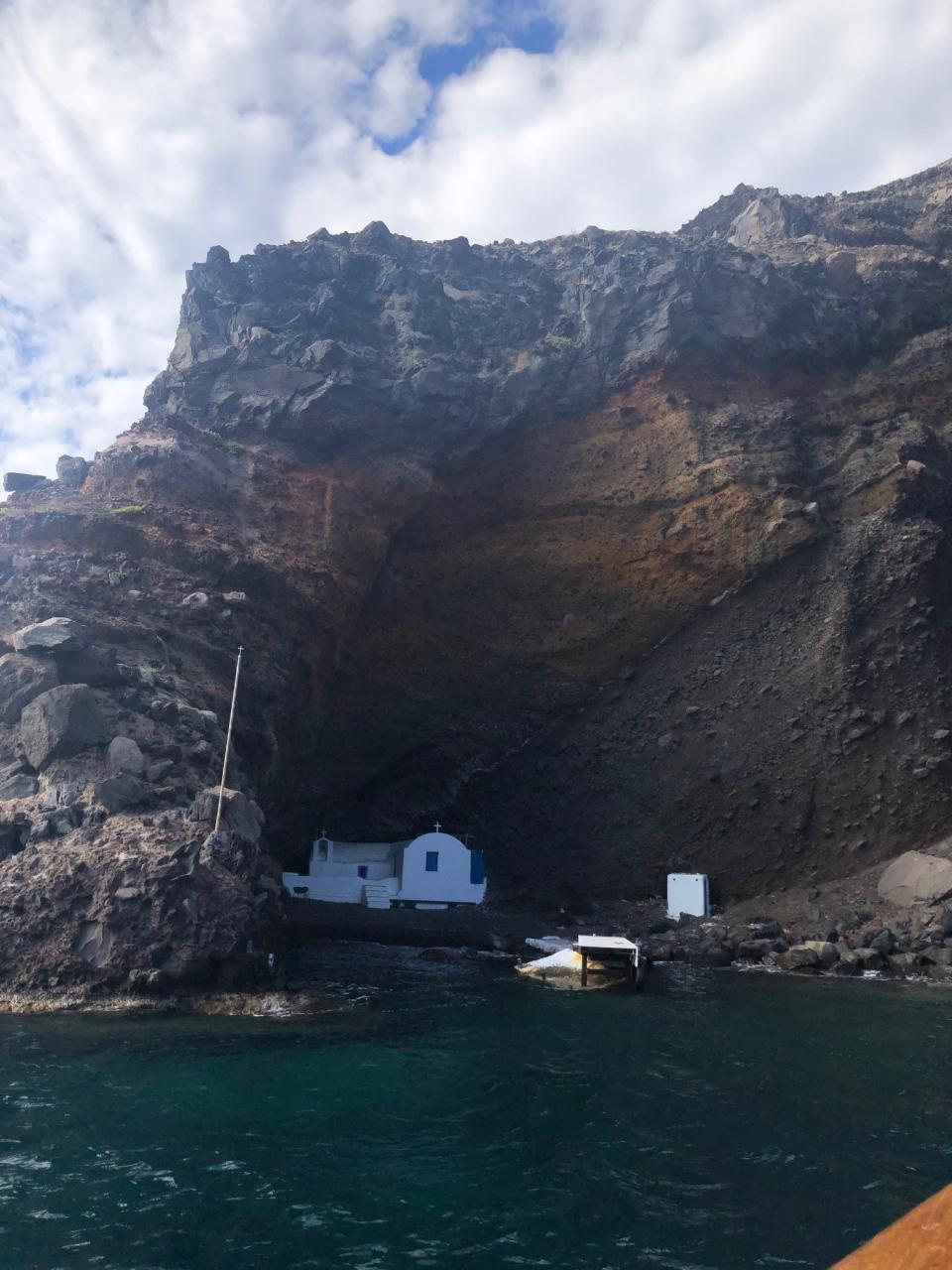 Church hidden in a nook in the volcanic rock