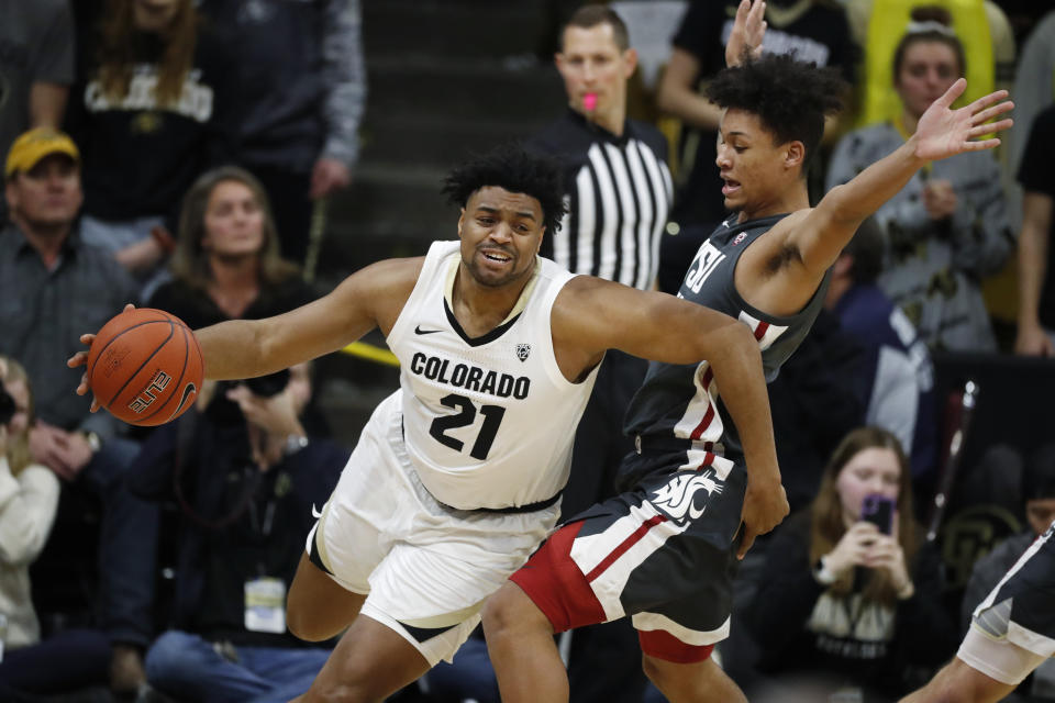 Colorado forward Evan Battey, left, drives past Washington State forward DJ Rodman in the first half of an NCAA college basketball game Thursday, Jan. 23, 2020, in Boulder, Colo. (AP Photo/David Zalubowski)