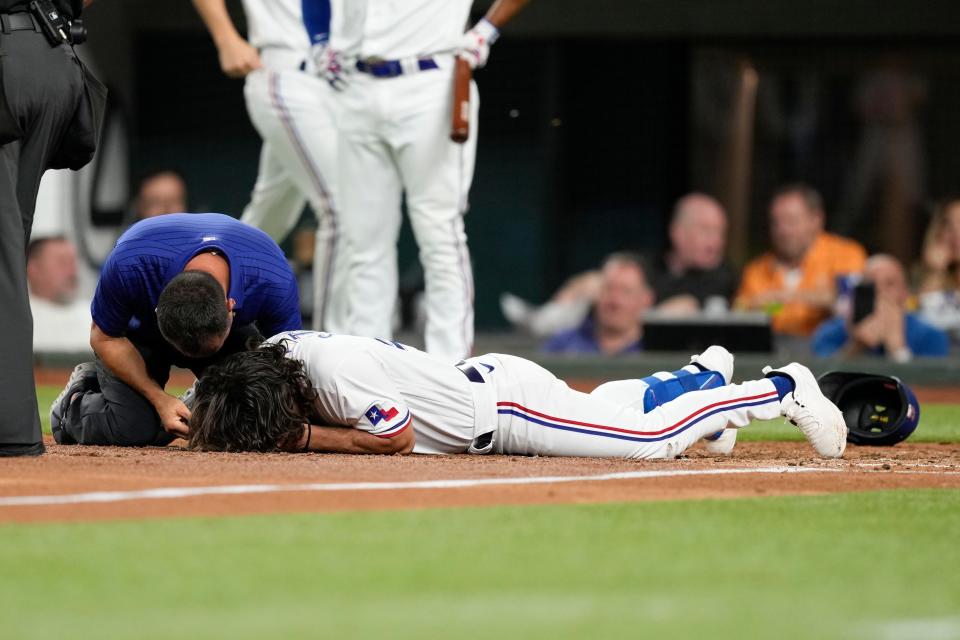 Josh Smith lies on the ground after getting hit by a pitch thrown by the Baltimore Orioles' Danny Coulombe.