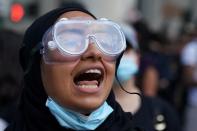 A protester chants slogans during a protest to defund the police in a place they are calling the "City Hall Autonomous Zone" in support of "Black Lives Matter" in the Manhattan borough of New York City