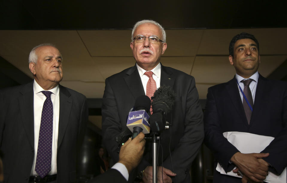 Palestinian minister of foreign affairs Riyad al-Maliki, center, speaks to reporters while Palestinian ambassador to the United Nations Riyad Mansour, left, and Palestinian official Omar Awdallah look on following a meeting in New York, Wednesday, Sept. 26, 2018. (AP Photo/Seth Wenig)