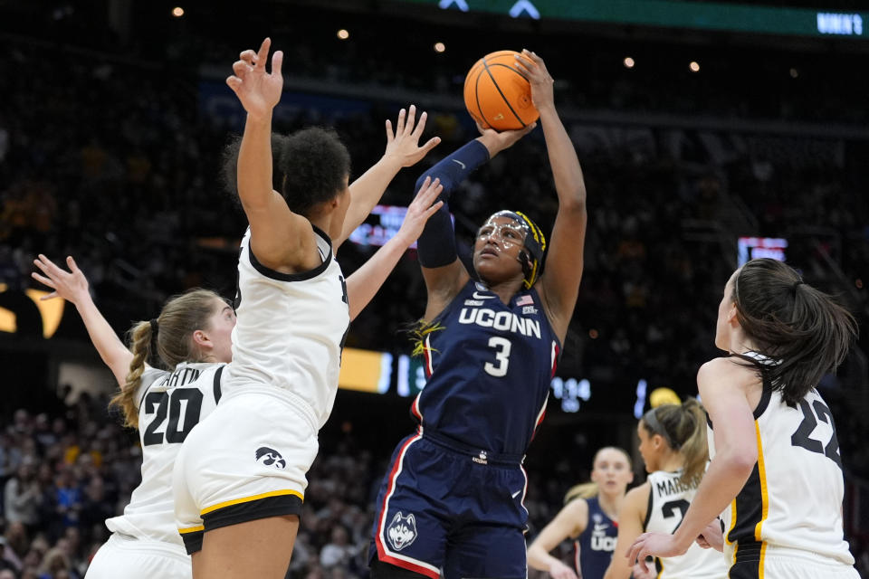 UConn forward Aaliyah Edwards (3) shoots over Iowa forward Hannah Stuelke during the first half of a Final Four college basketball game in the women's NCAA Tournament, Friday, April 5, 2024, in Cleveland. (AP Photo/Morry Gash)