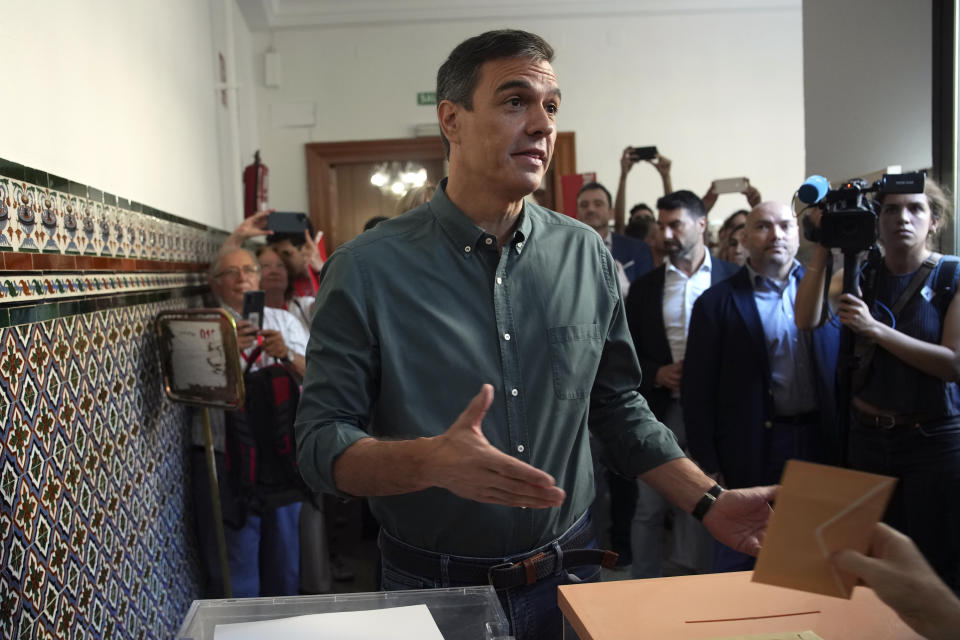Spain's Prime Minister and Socialist Workers' Party Pedro Sanchez gestures as his ballot is introduced in the ballot box during Spain's general election in Madrid, Spain, Sunday July 23, 2023. Voters in Spain go to the polls Sunday in an election that could make the country the latest European Union member swing to the populist right, a shift that would represent a major upheaval after five years under a left-wing government. (AP Photo/Emilio Morenatti)