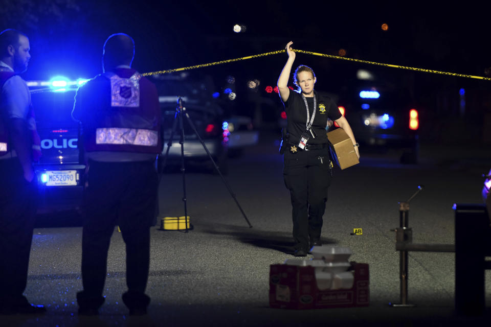 A member of the sheriff's department exits the crime scene on Ashton Drive in the Vintage Place neighborhood where several members of law enforcement were shot, one fatally, Wednesday, Oct. 3, 2018, in Florence, S.C. (AP Photo/Sean Rayford)