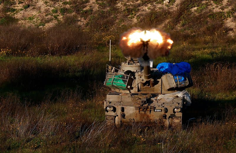 An Israeli artillery unit fires towards Gaza, near the northern Gaza Strip border