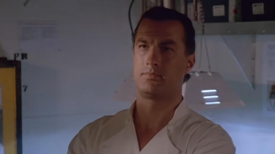 Steven Seagal looking serious in a chef outfit.