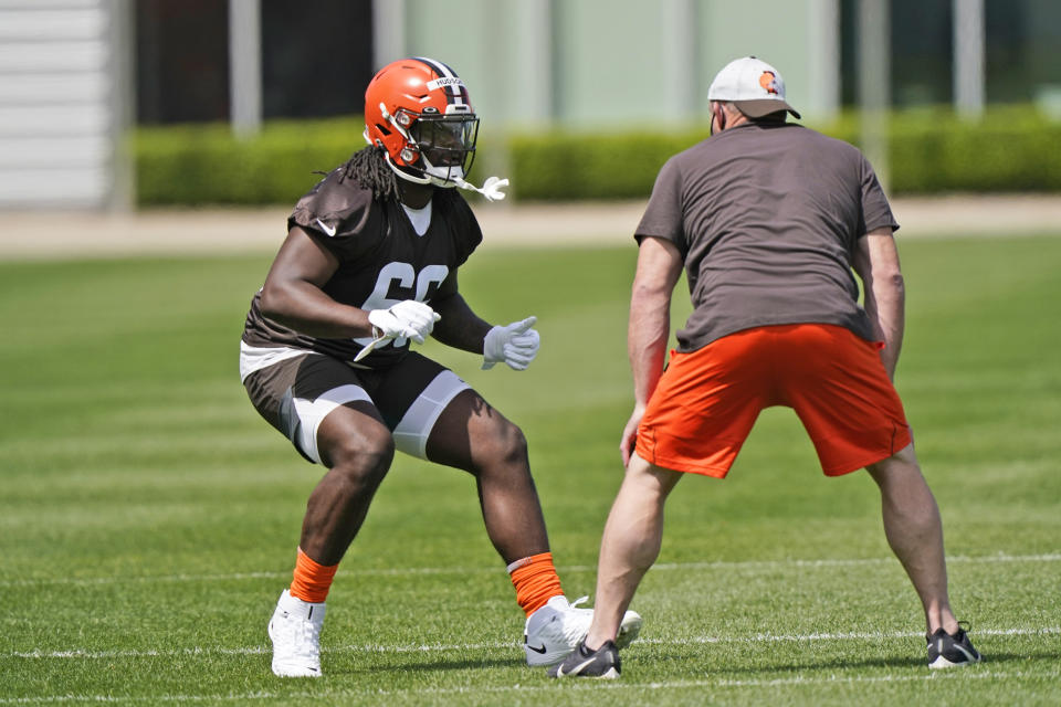 Cleveland Browns tackle James Hudson III, left, runs a drill during an NFL football rookie minicamp at the team's training camp facility, Friday, May 14, 2021, in Berea, Ohio. (AP Photo/Tony Dejak)