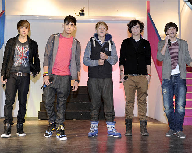 Performing at Louis Tomlinson's old school, the boys clearly could have done with some style advice rocking strange pyjama-style booties, and cardies. Except Harry, who is already becoming the front-runner in the fashion stakes.