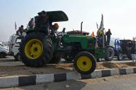 Farmers take part in a tractor rally as they continue to demonstrate against the central government's recent agricultural reforms in New Delhi on January 26, 2021. (Photo by Money SHARMA / AFP) (Photo by MONEY SHARMA/AFP via Getty Images)