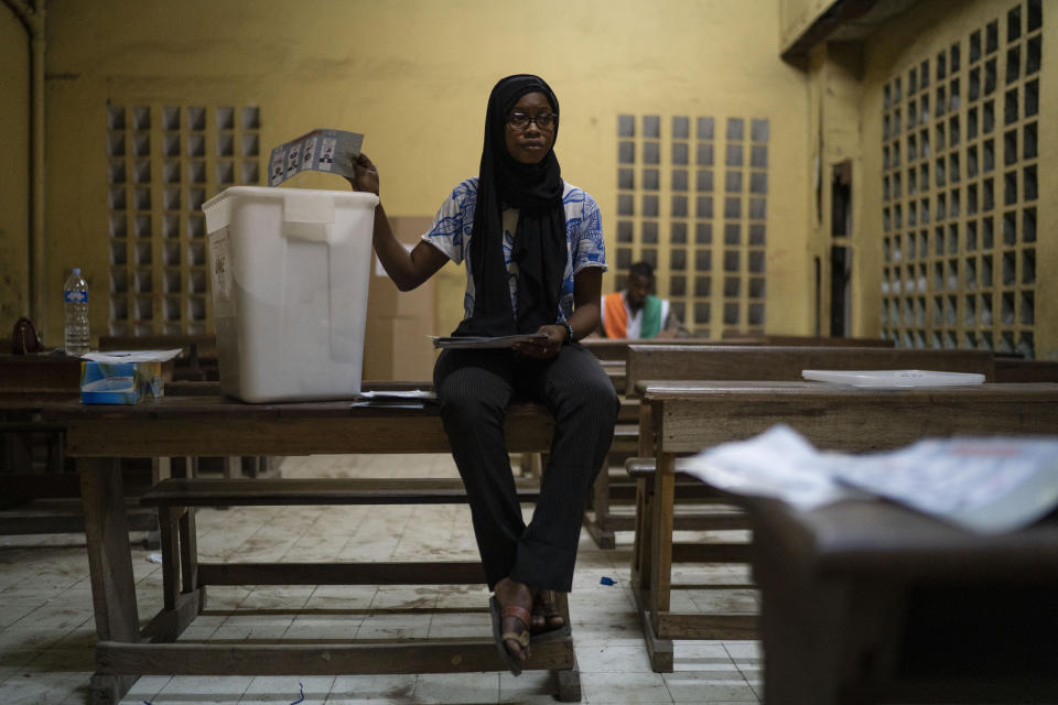 A poll worker counts votes at a polling station during presidential elections in Abidjan, Ivory Coast, Saturday, Oct. 31, 2020. Some tens of thousands of security forces have been deployed across the Ivory Coast on Saturday as the leading opposition parties boycotted the election, calling President Ouattara's bid for a third term illegal. (AP Photo/Leo Correa)