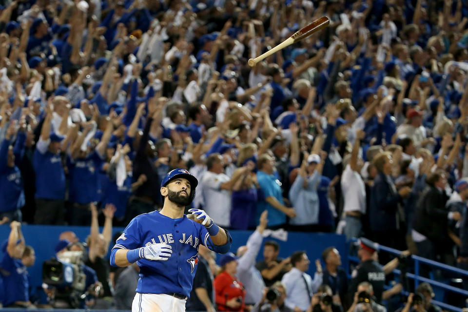 TORONTO, ON - OCTOBER 14:  Jose Bautista #19 of the Toronto Blue Jays flips his bat up in the air after he hits a three-run home run in the seventh inning against the Texas Rangers in game five of the American League Division Series at Rogers Centre on October 14, 2015 in Toronto, Canada.  (Photo by Tom Szczerbowski/Getty Images)