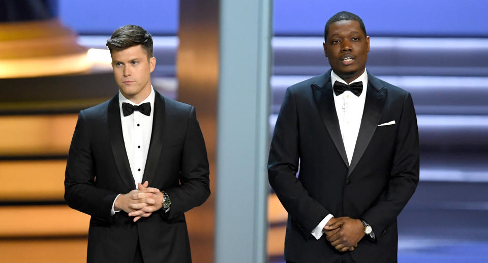 Colin Jost and Michael Che speak onstage during the 70th Emmy Awards. (Photo: Kevin Winter/Getty Images)