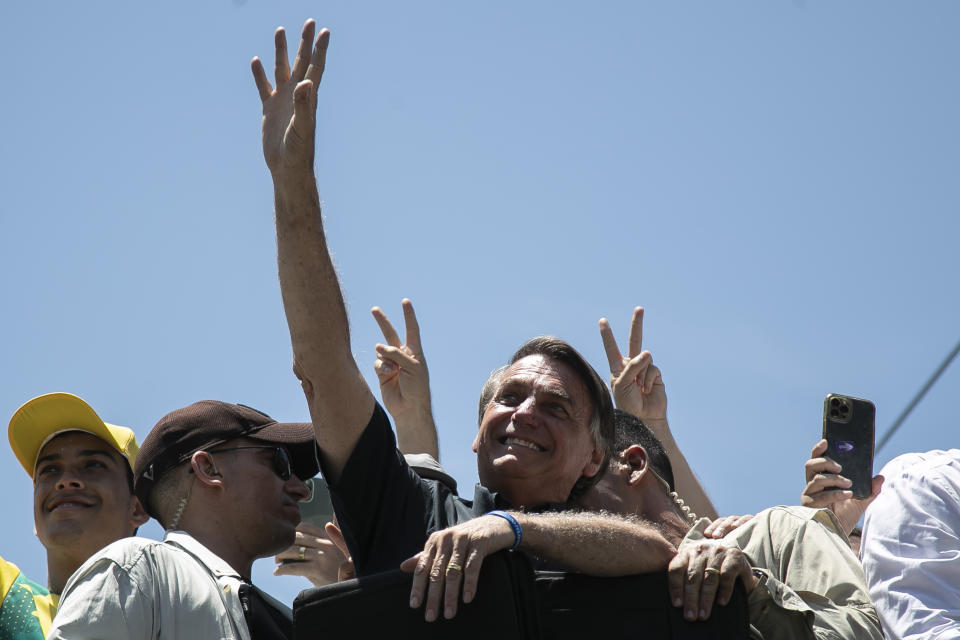 Brazil's President Jair Bolsonaro greets supporters during a campaign rally in Belford Roxo, Rio de Janeiro state, Brazil, Thursday, Oct. 27, 2022. Bolsonaro is facing former President Luiz Inacio Lula da Silva in a runoff election set for Oct. 30. (AP Photo/Bruna Prado)