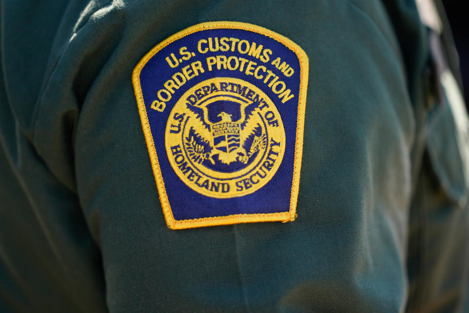 An agents wears a U.S. Customs and Border Protection badge 