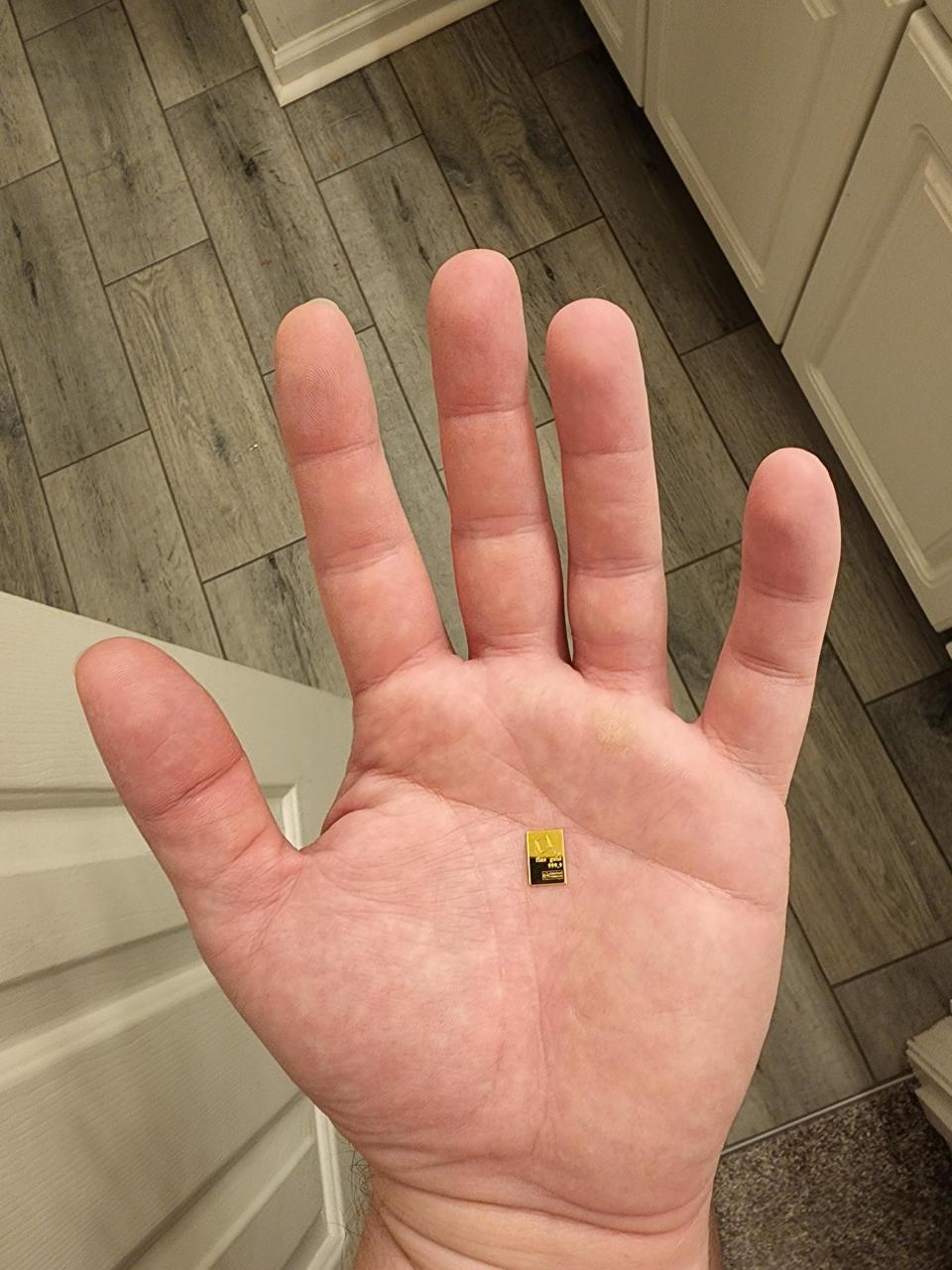 A tiny rectangular dot in the middle of a person's palm