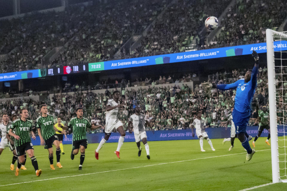 Toronto goalkeeper Sean Johnson, right, dives for a shot on goal during the second half of an MLS soccer game against Austin FC, Saturday, May 20, 2023, in Austin, Texas. The shot went wide. (AP Photo/Michael Thomas)